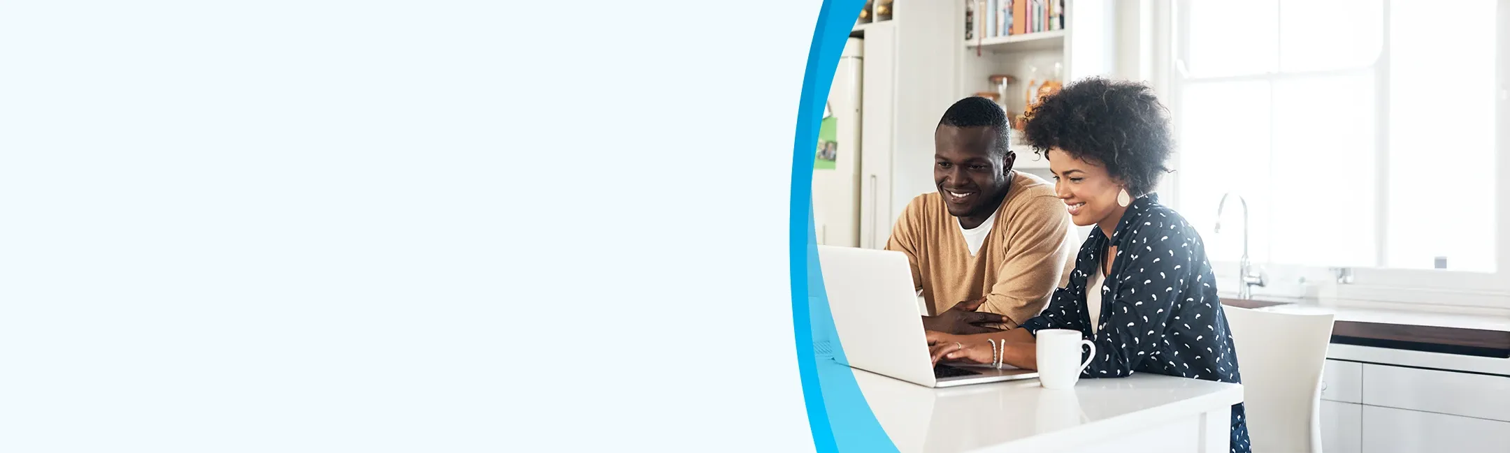 Couple in kitchen with laptop